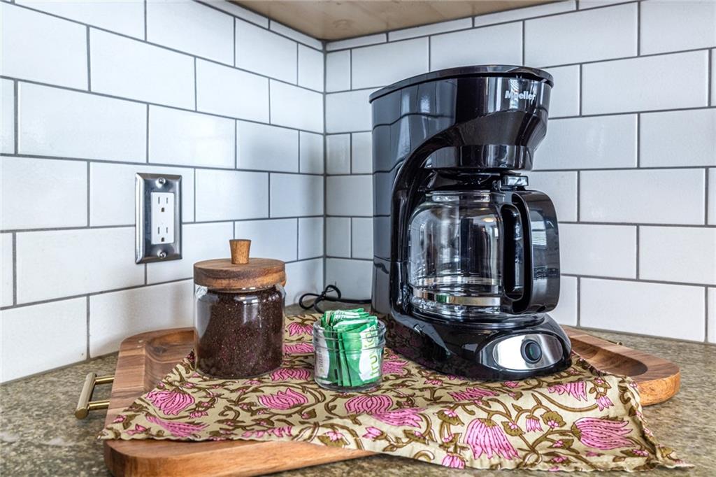 69 Randolph Street Northeast, Unit A Atlanta, GA 30312 - Photo 23 of 50 a kitchen with a stove and a wooden floor