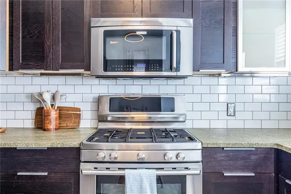 a stove top oven sitting inside of a kitchen