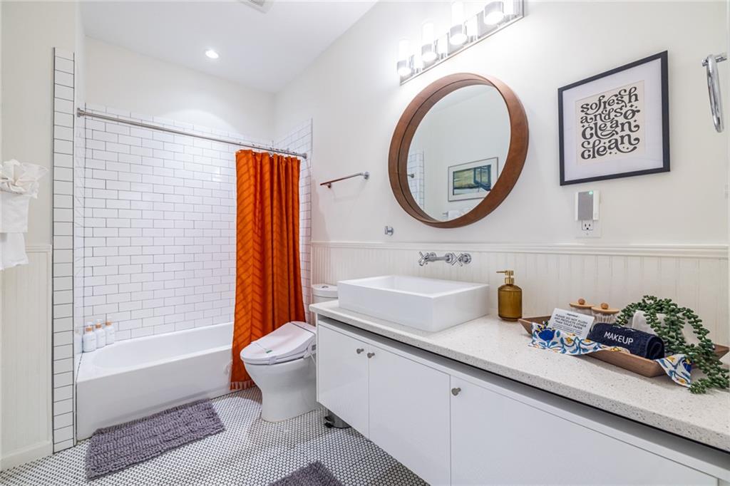 69 Randolph Street Northeast, Unit A Atlanta, GA 30312 - Photo 32 of 50 a bathroom with a sink a toilet and a shower