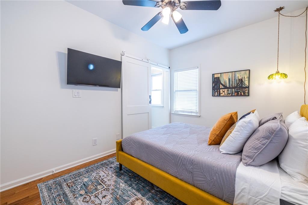 69 Randolph Street Northeast, Unit A Atlanta, GA 30312 - Photo 38 of 50 a bedroom with a bed and ceiling fan