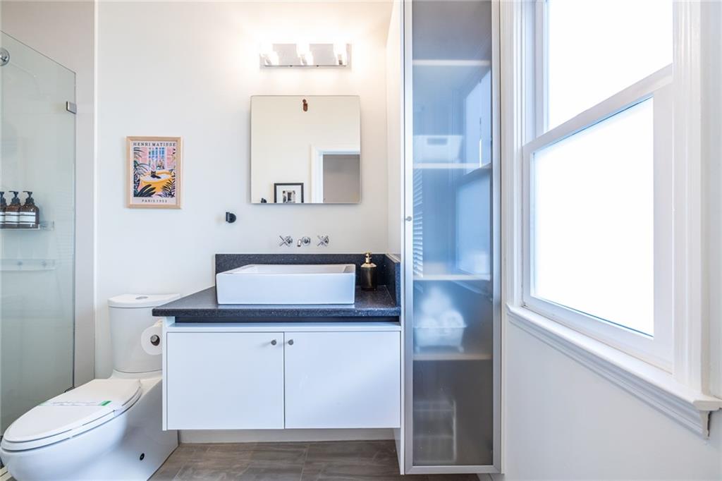 69 Randolph Street Northeast, Unit A Atlanta, GA 30312 - Photo 41 of 50 a bathroom with a sink toilet vanity and mirror