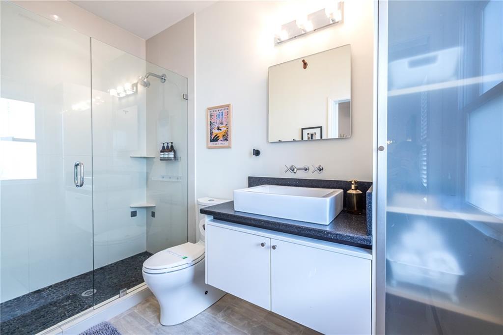 69 Randolph Street Northeast, Unit A Atlanta, GA 30312 - Photo 42 of 50 a bathroom with a sink a toilet and shower