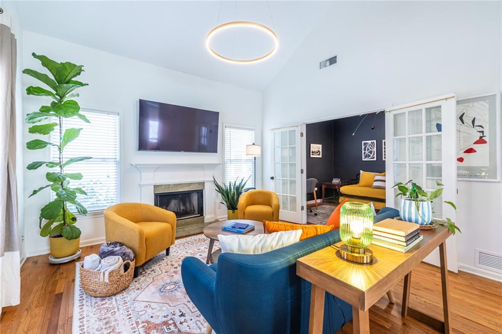 69 Randolph Street Northeast, Unit A Atlanta, GA 30312 - Photo 7 of 50 a living room with furniture a fireplace and a potted plant