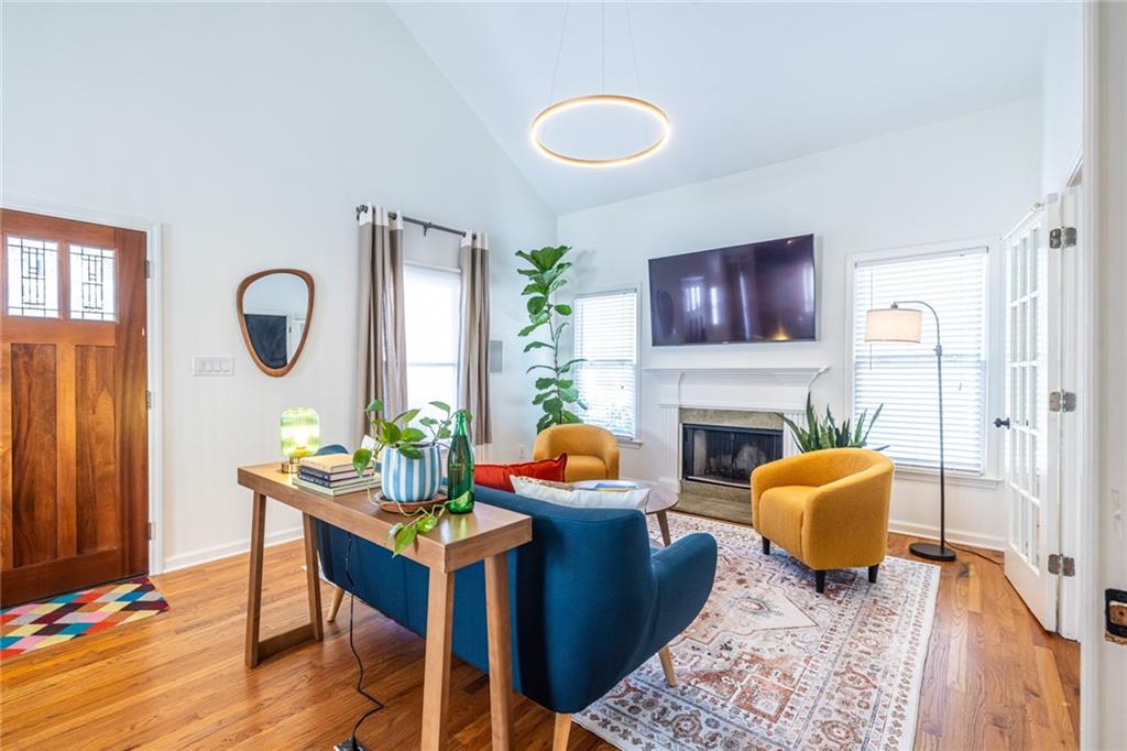 69 Randolph Street Northeast, Unit A Atlanta, GA 30312 - Photo 8 of 50 a living room with fireplace furniture and a wooden floor