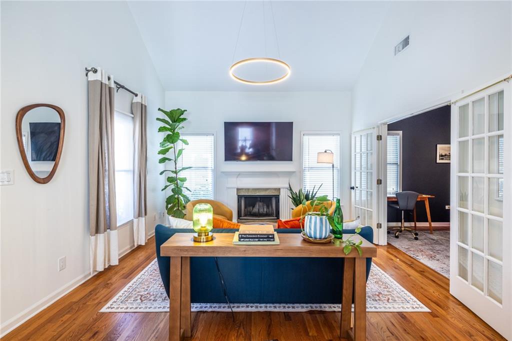 69 Randolph Street Northeast, Unit A Atlanta, GA 30312 - Photo 9 of 50 a living room with furniture a fireplace and a table
