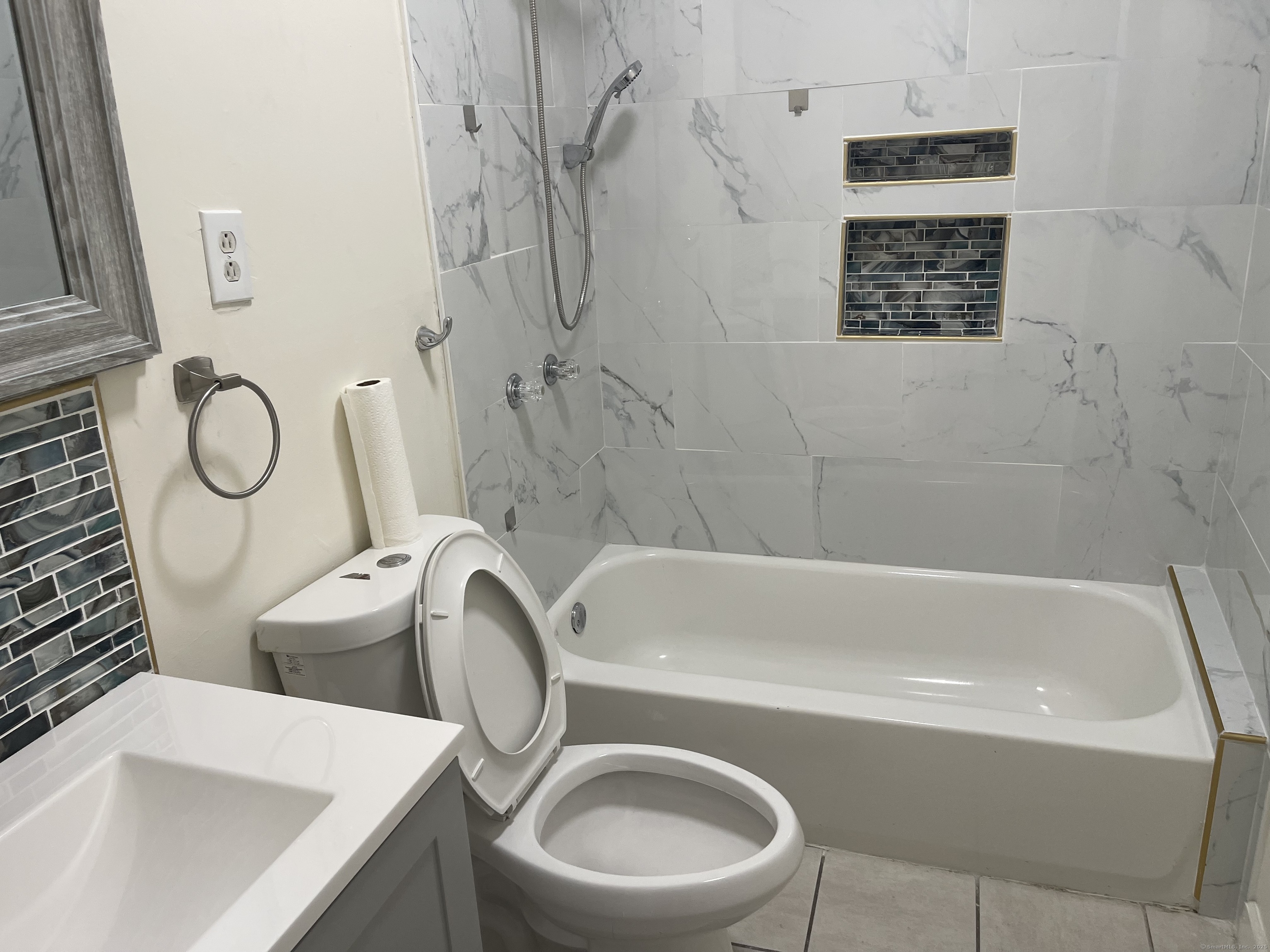 Undisclosed Address Bridgeport, CT 06607 - Photo 2 of 11 a bathroom with a sink a toilet and bathtub