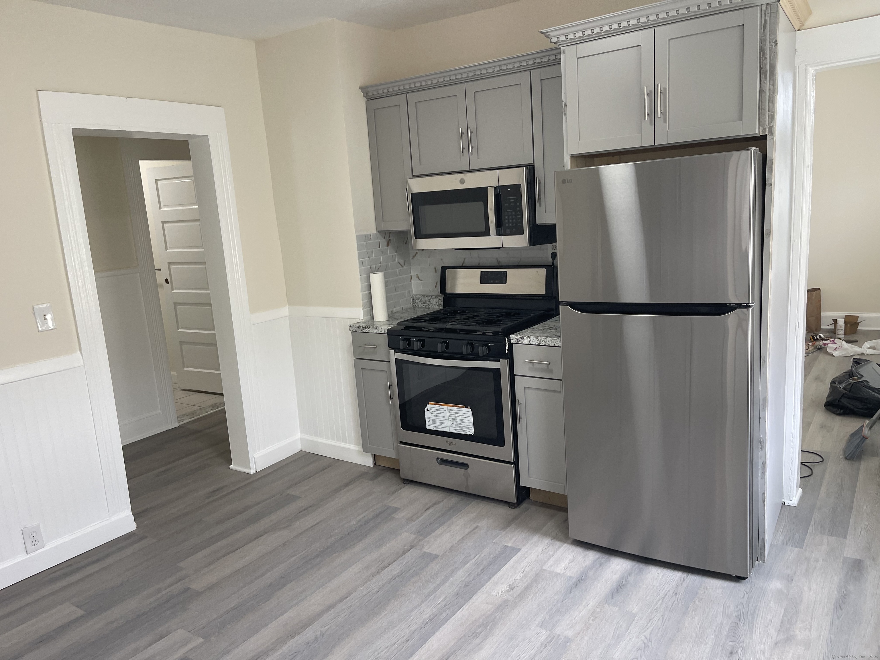 Undisclosed Address Bridgeport, CT 06607 - Photo 5 of 11 a kitchen with a refrigerator a stove and cabinets