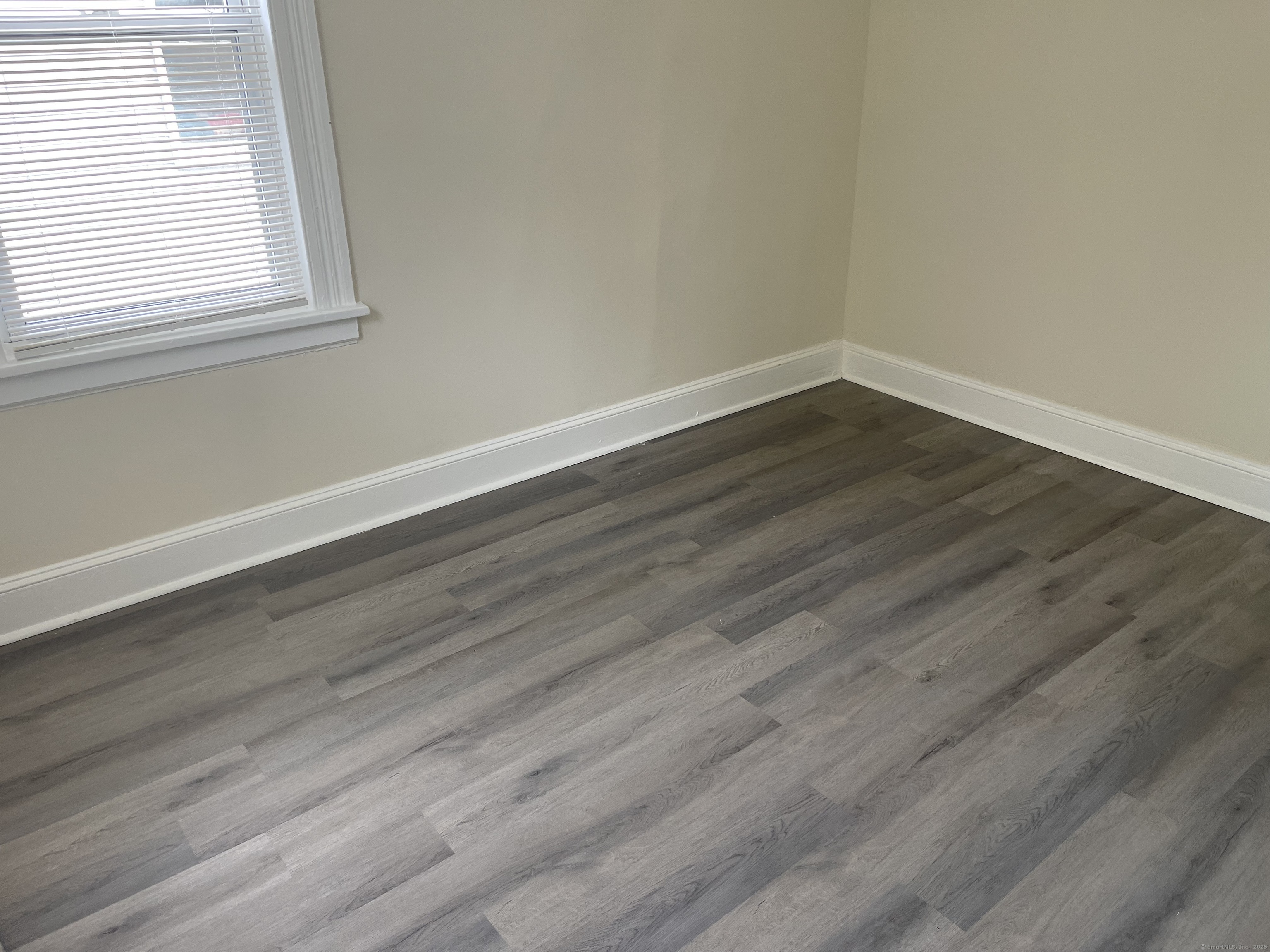 Undisclosed Address Bridgeport, CT 06607 - Photo 7 of 11 a view of a small space with wooden floor and a window