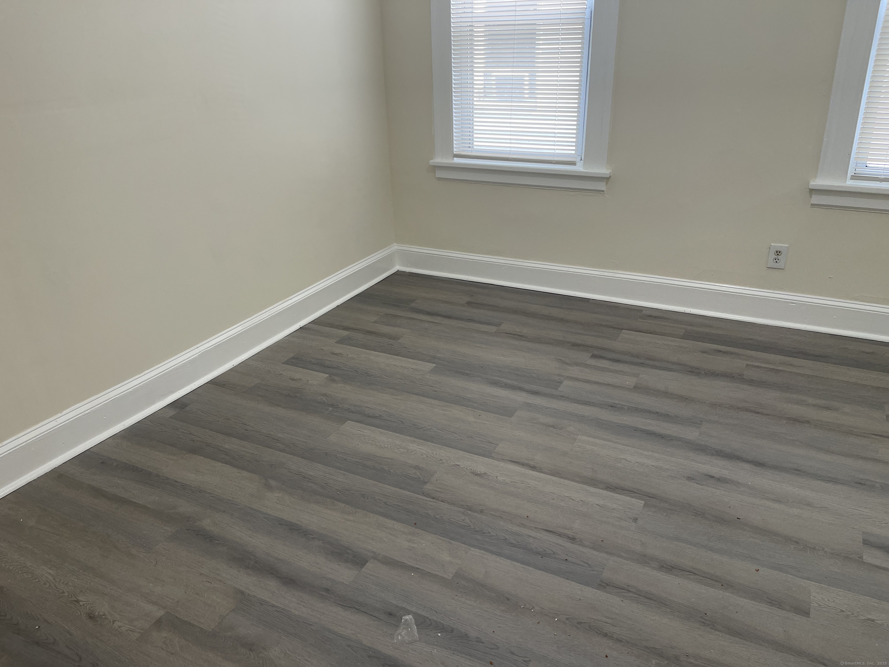 Undisclosed Address Bridgeport, CT 06607 - Photo 9 of 11 an empty room with wooden floor and windows