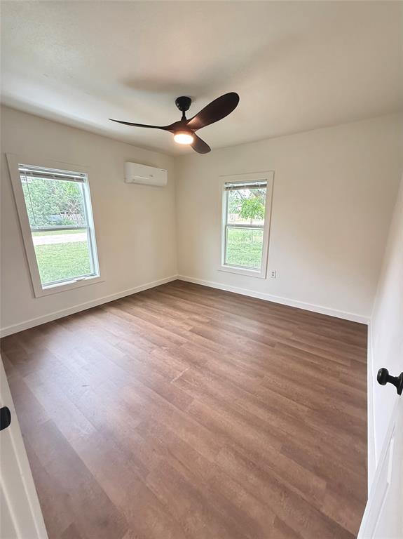 610 5th Street Hawley, TX 79525 - Photo 11 of 19 wooden floor in an empty room with a window