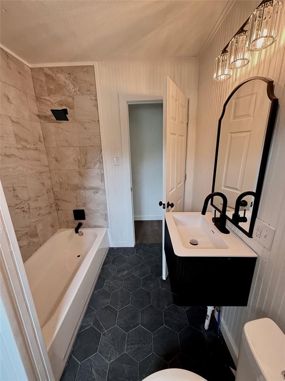 610 5th Street Hawley, TX 79525 - Photo 15 of 19 a bathroom with a sink a toilet and tub