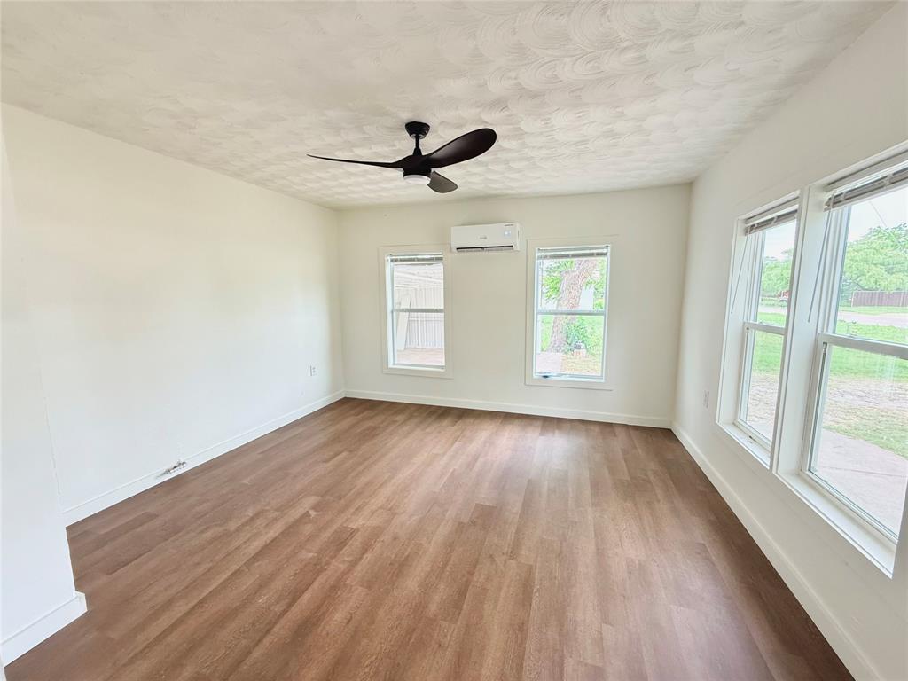 610 5th Street Hawley, TX 79525 - Photo 16 of 19 wooden floor in an empty room with a window