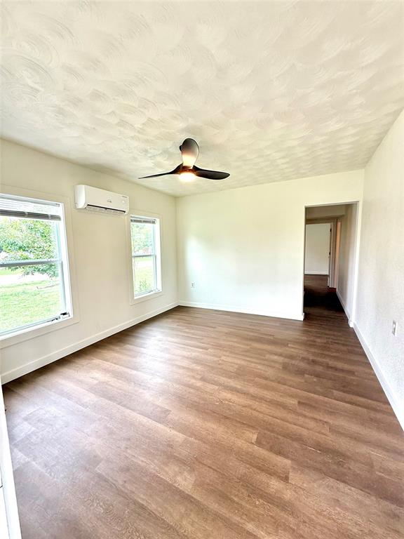 610 5th Street Hawley, TX 79525 - Photo 17 of 19 a view of empty room with wooden floor and fan