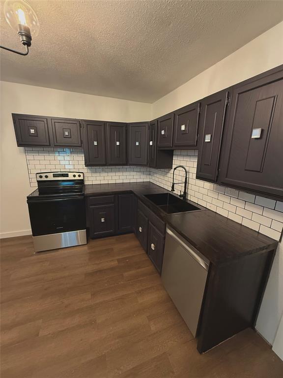 610 5th Street Hawley, TX 79525 - Photo 4 of 19 a kitchen with stainless steel appliances granite countertop a sink and stove