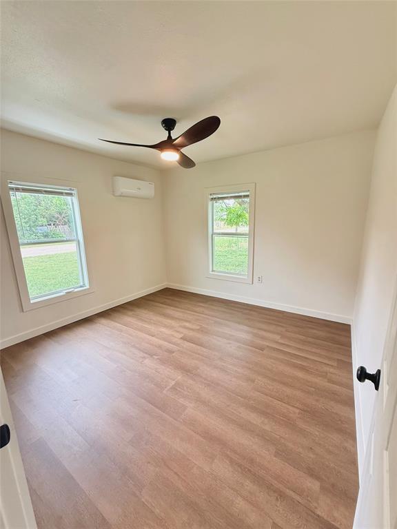 610 5th Street Hawley, TX 79525 - Photo 9 of 19 wooden floor in an empty room with a window