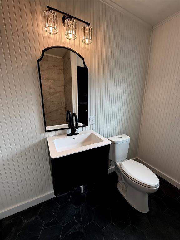 610 5th Street Hawley, TX 79525 - Photo 10 of 19 a bathroom with a toilet sink and mirror
