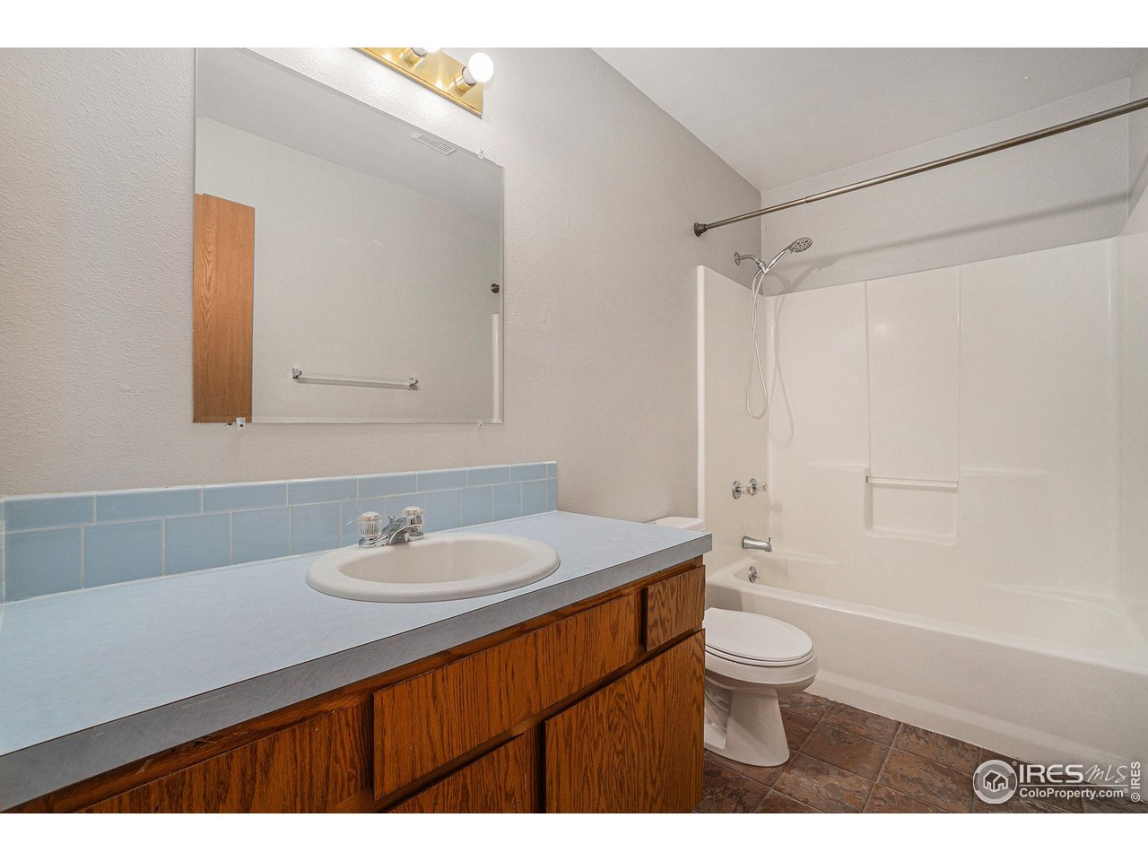 1634 San Juan Circle Evans, CO 80620 - Photo 9 of 20 a bathroom with a sink a toilet and shower