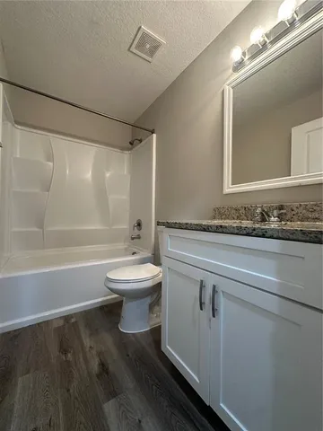 a bathroom with a toilet a sink and bathtub