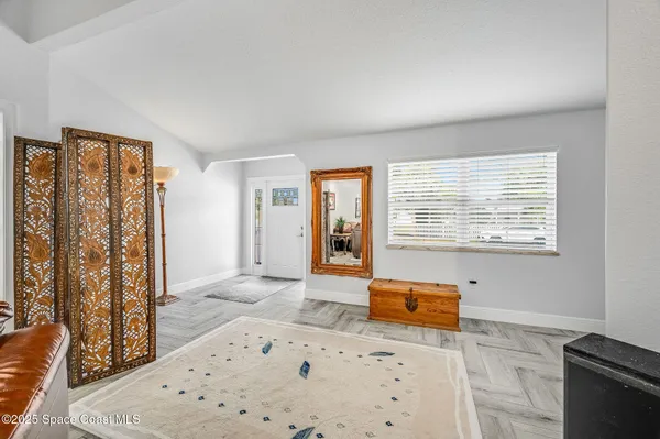 a living room with furniture and a dining table