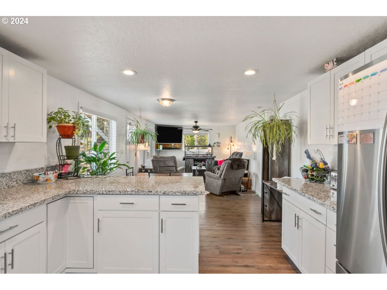 1147 33rd Street Springfield, OR 97478 - Photo 11 of 44 a kitchen with stainless steel appliances kitchen island granite countertop a refrigerator and a sink