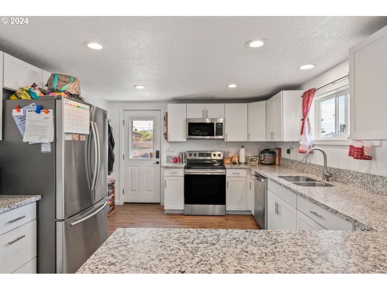1147 33rd Street Springfield, OR 97478 - Photo 13 of 44 a kitchen with stainless steel appliances granite countertop a refrigerator sink and stove