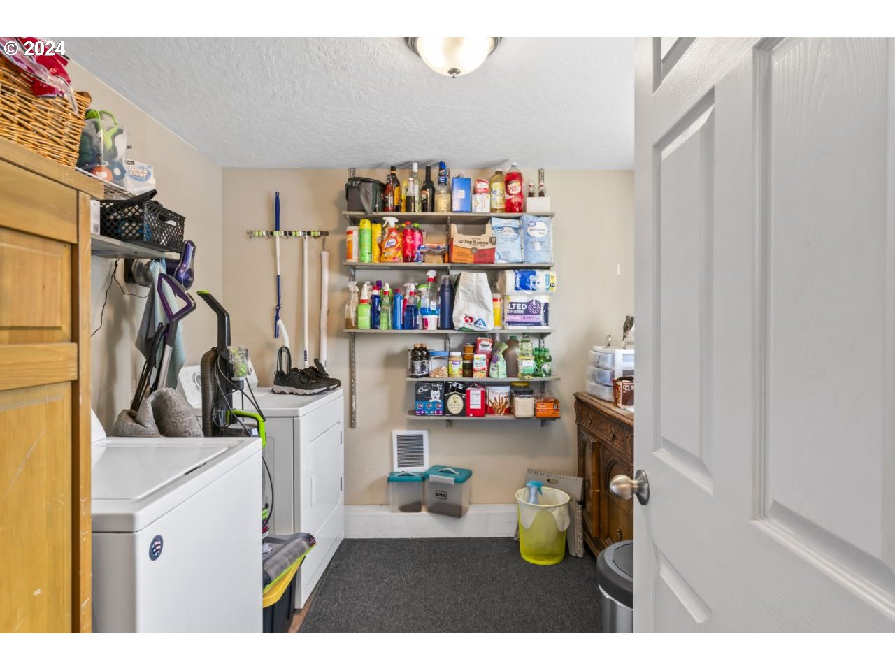 1147 33rd Street Springfield, OR 97478 - Photo 15 of 44 a storage room with lots of clutter and refrigerator