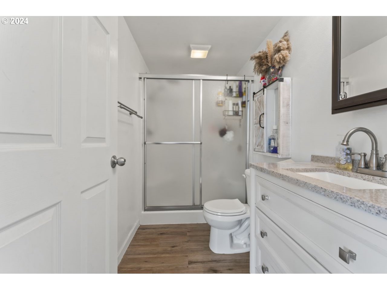 1147 33rd Street Springfield, OR 97478 - Photo 29 of 44 a bathroom with a granite countertop sink toilet and shower