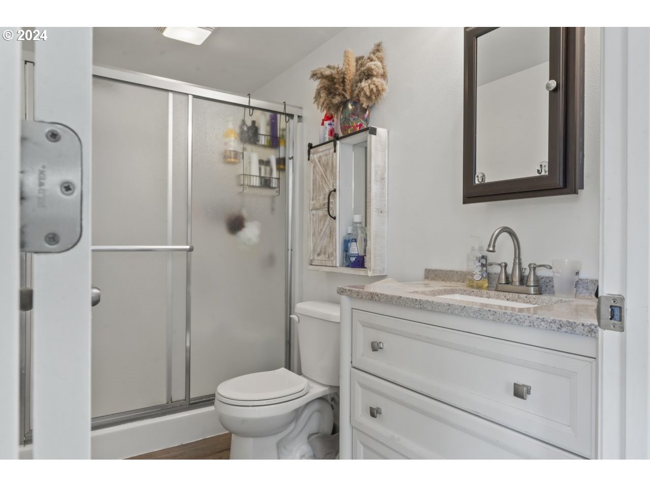 1147 33rd Street Springfield, OR 97478 - Photo 30 of 44 a bathroom with a granite countertop sink toilet and shower
