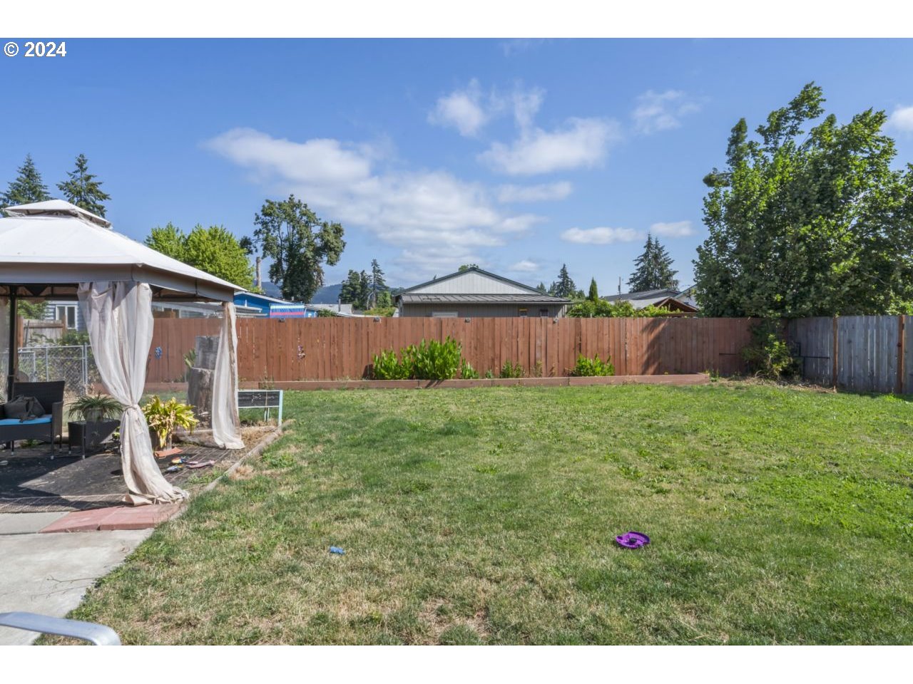 1147 33rd Street Springfield, OR 97478 - Photo 43 of 44 a view of a backyard with table and chairs and wooden fence