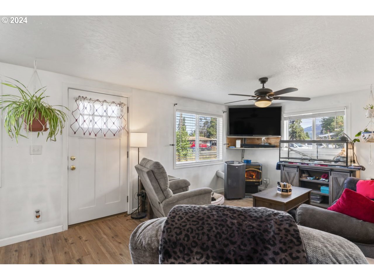1147 33rd Street Springfield, OR 97478 - Photo 5 of 44 a living room with furniture a flat screen tv and a fireplace