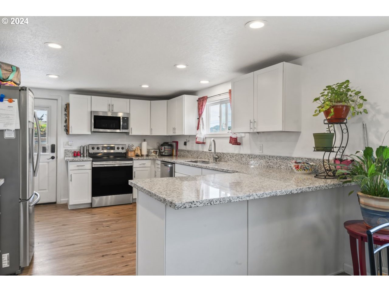 1147 33rd Street Springfield, OR 97478 - Photo 8 of 44 a kitchen with granite countertop a stove a sink and a refrigerator
