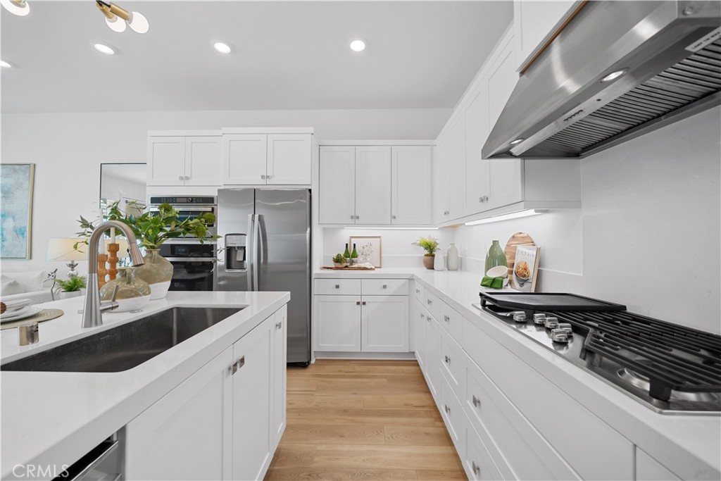 163 Baluster Irvine, CA 92618 - Photo 12 of 32 a kitchen with a sink stainless steel appliances and cabinets