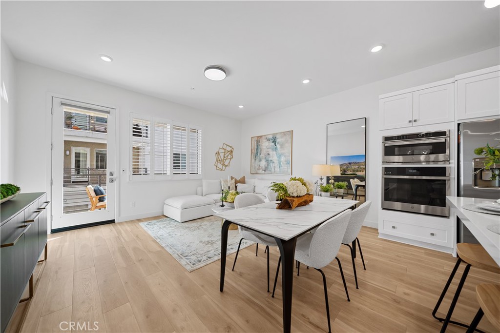163 Baluster Irvine, CA 92618 - Photo 13 of 32 a living room with stainless steel appliances furniture a rug kitchen view and a kitchen island