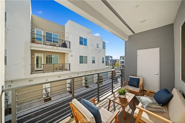 a view of living room filled with furniture and baby crib