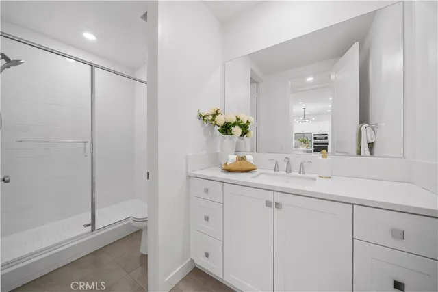 a bathroom with a shower sink and mirror