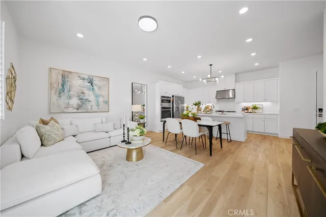 a living room with furniture and kitchen view