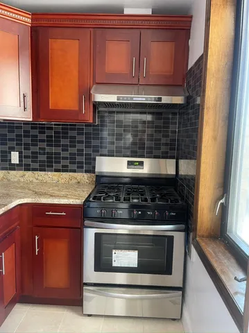 a stove top oven sitting inside of a kitchen