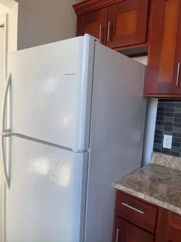 a view of a refrigerator in kitchen