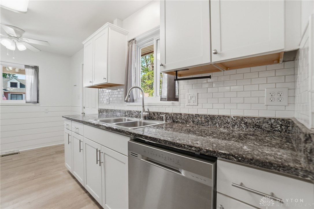 629 Storms Road Dayton, OH 45429 - Photo 21 of 51 This bright kitchen features modern white cabinetry and sleek appliances.