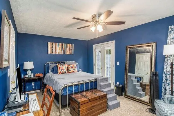 a bedroom with a bed and a chandelier
