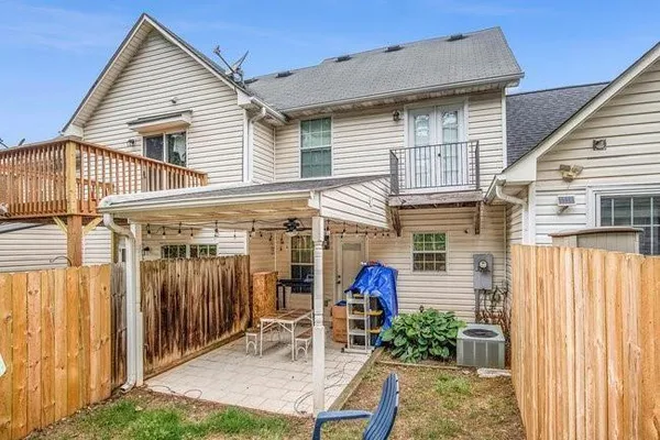 a view of a house with a porch and furniture