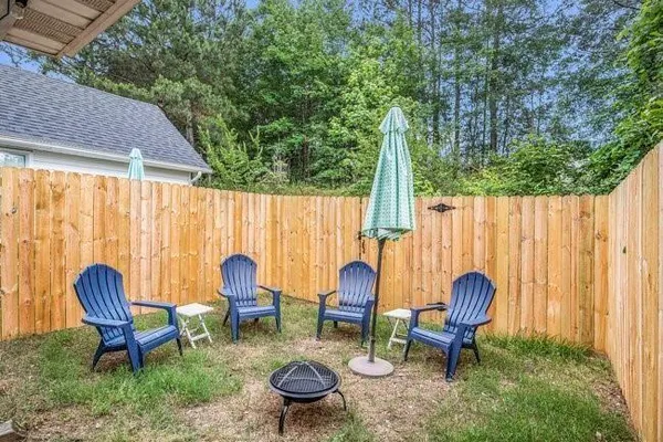 a backyard of a house with table and chairs