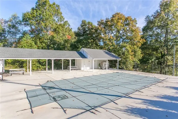 a view of house with backyard and glass windows