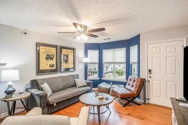 a living room with furniture a table and a window