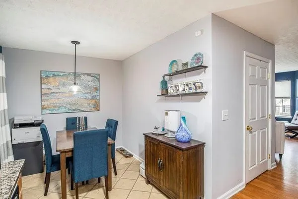 a dining room with furniture a window and wooden floor