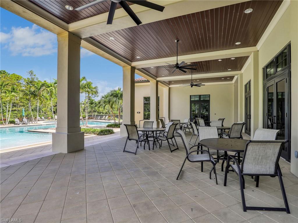 4383 Bismark Way Naples, FL 34119 - Photo 42 of 49 Clubhouse Outdoor Covered Patio Dining Area & Community Pool