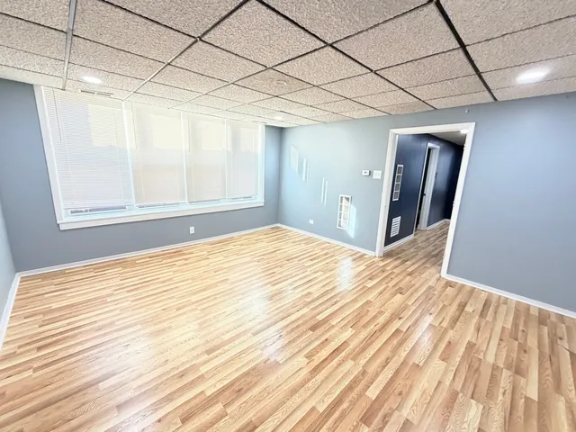 a view of empty room with wooden floor