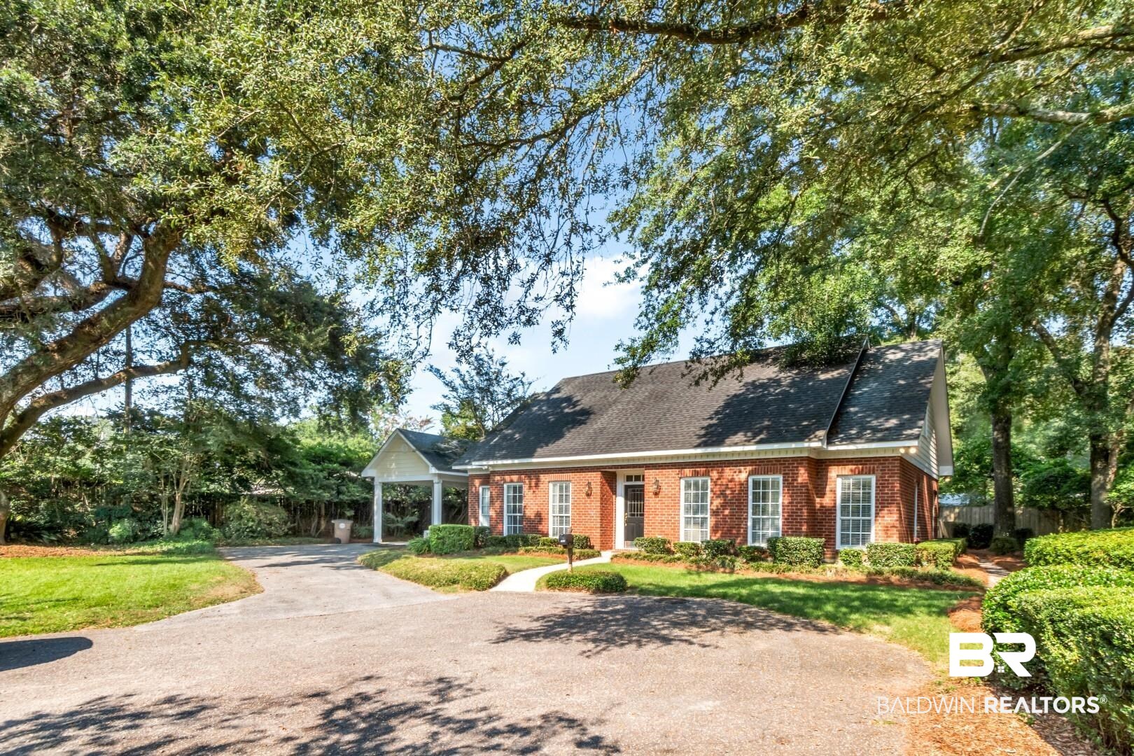 105 McHugh Lane Mobile, AL 36608 - Photo 29 of 30 Cape cod house with driveway, brick siding, a front yard, and a shingled roof
