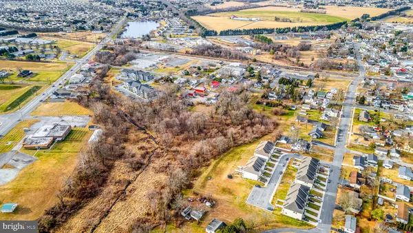 an aerial view of residential houses with yard