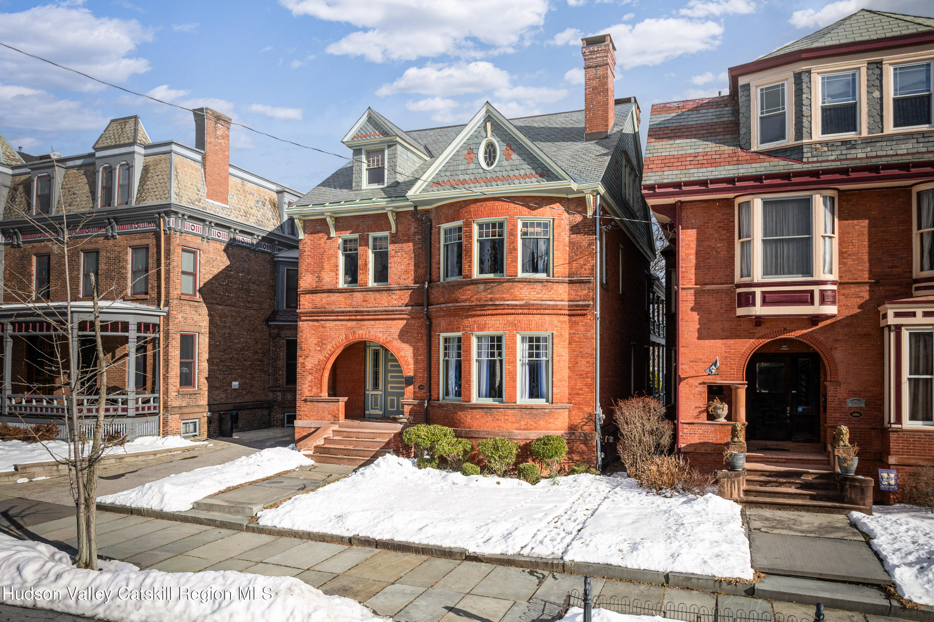164 Grand Street Newburgh, NY 12550 - Photo 1 of 59 a view of a brick house with many windows next to a road